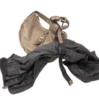 My Fave Jacket Strap holding a jacket on a purse